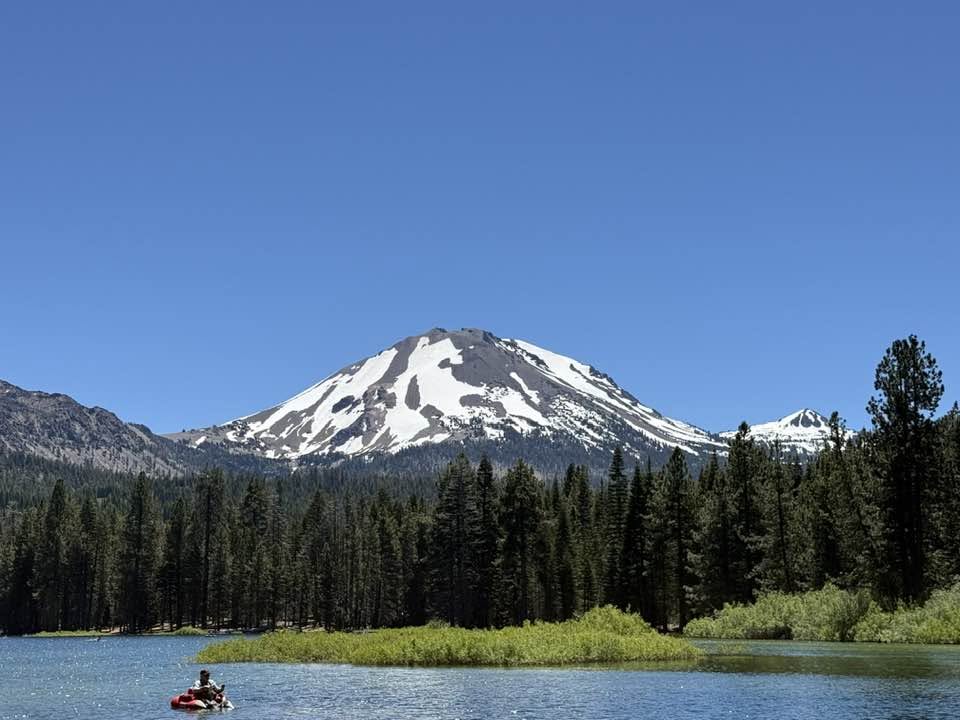 Snow-capped Lassen Peak rising above Manzanita Lake in Lassen Volcanic National Park, about an hour east of Redding