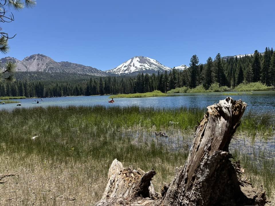 Kayakers on Manzanita Lake beneath Lassen Peak in Lassen Volcanic National Park