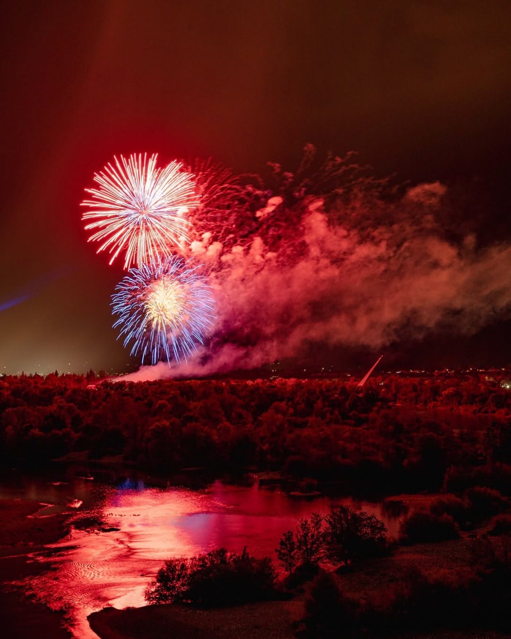 Fourth of July fireworks reflected on the Sacramento River beside the Sundial Bridge in Redding, California